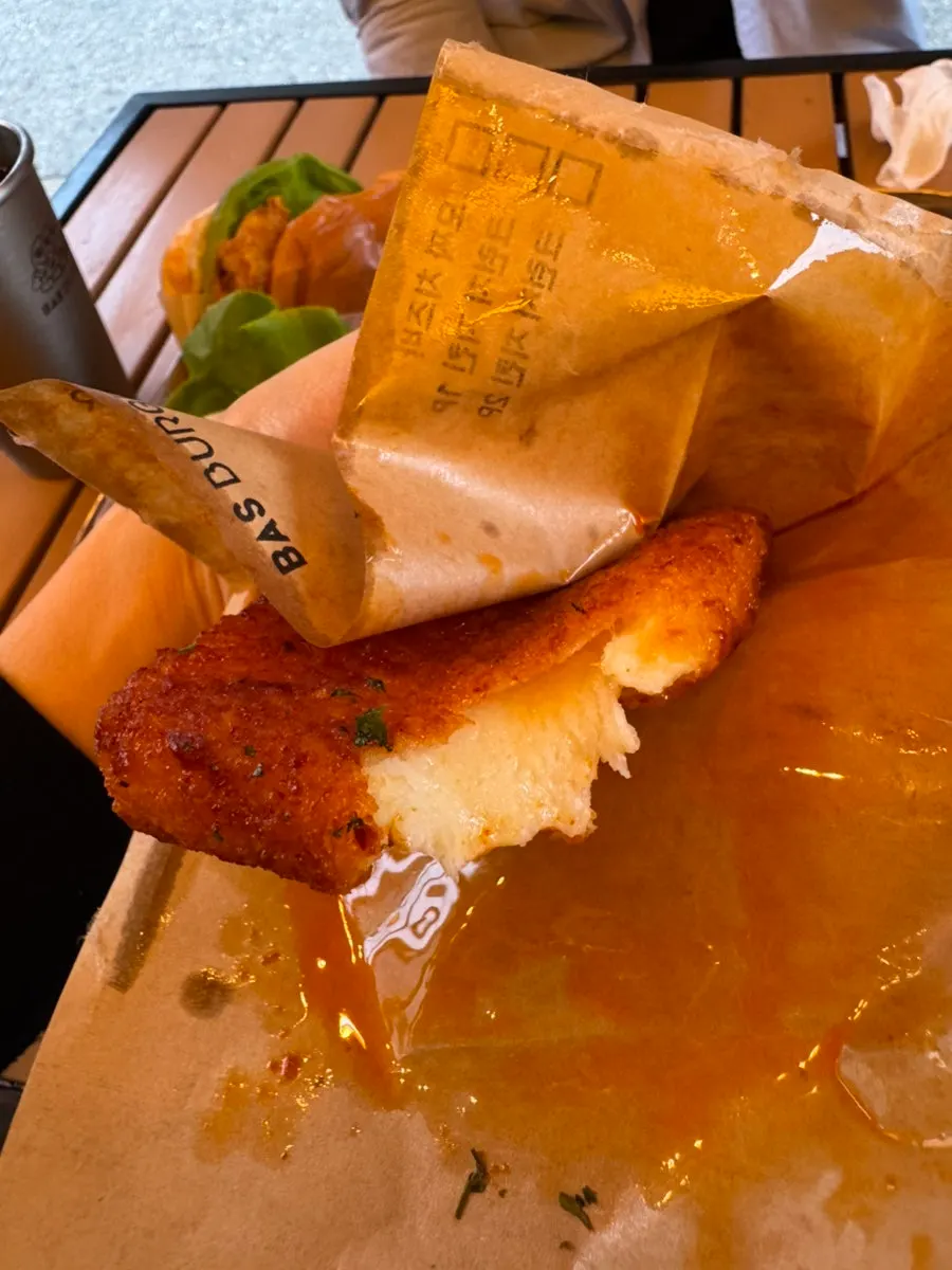 Chicken burger held in hand while eating