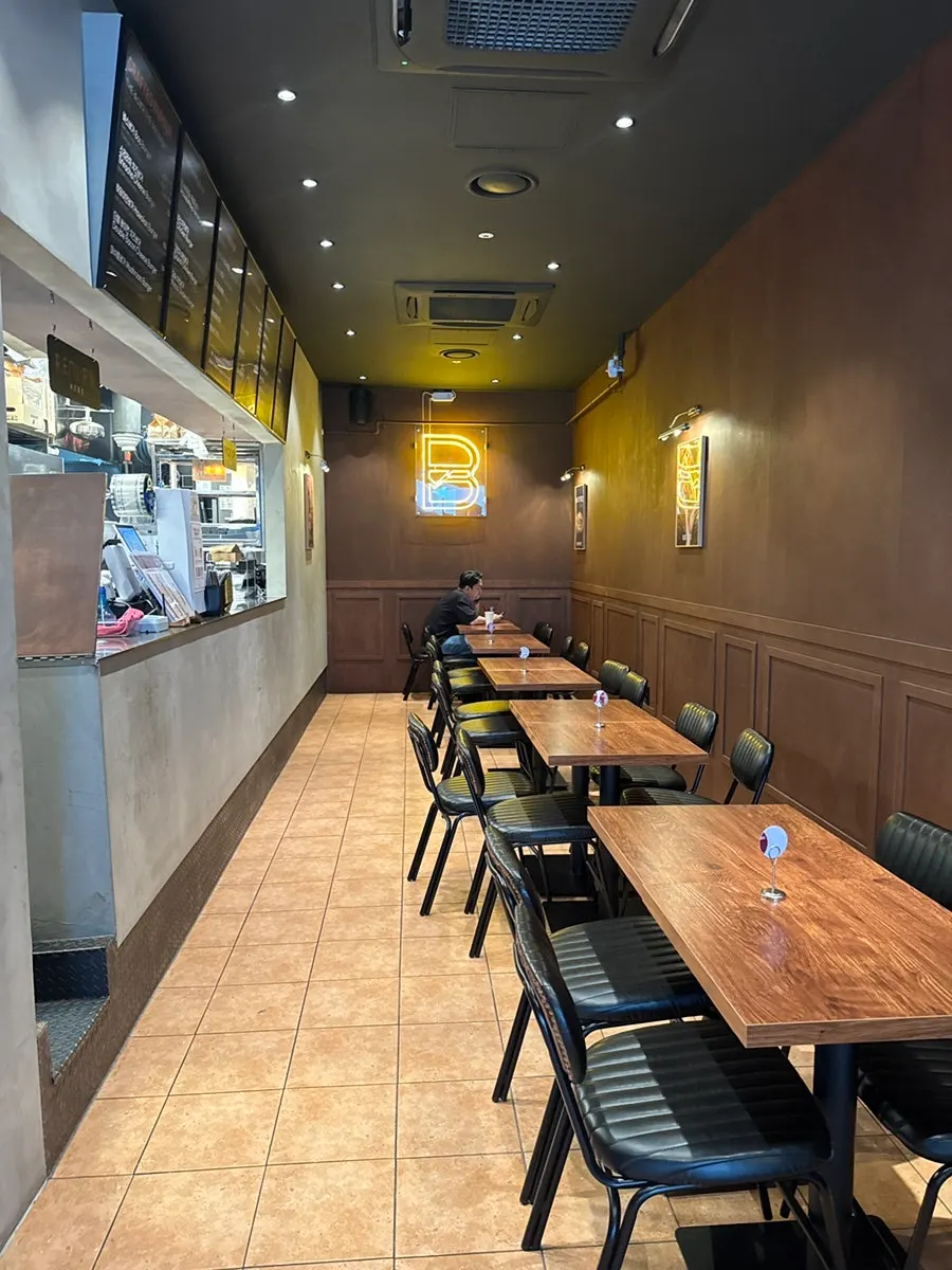 Interior of Base Burger in wood-brown tones