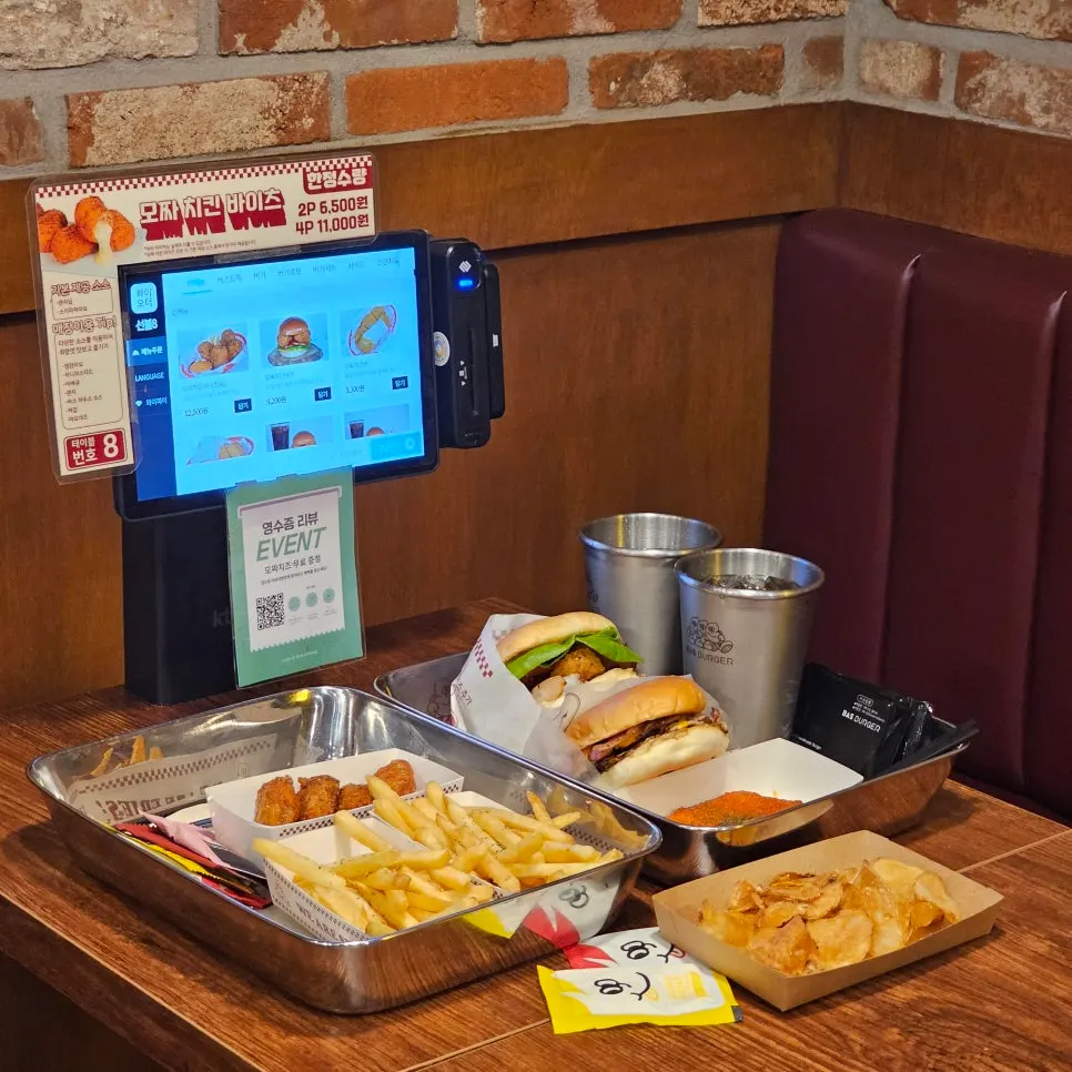 Two burger sets with side dishes on the table