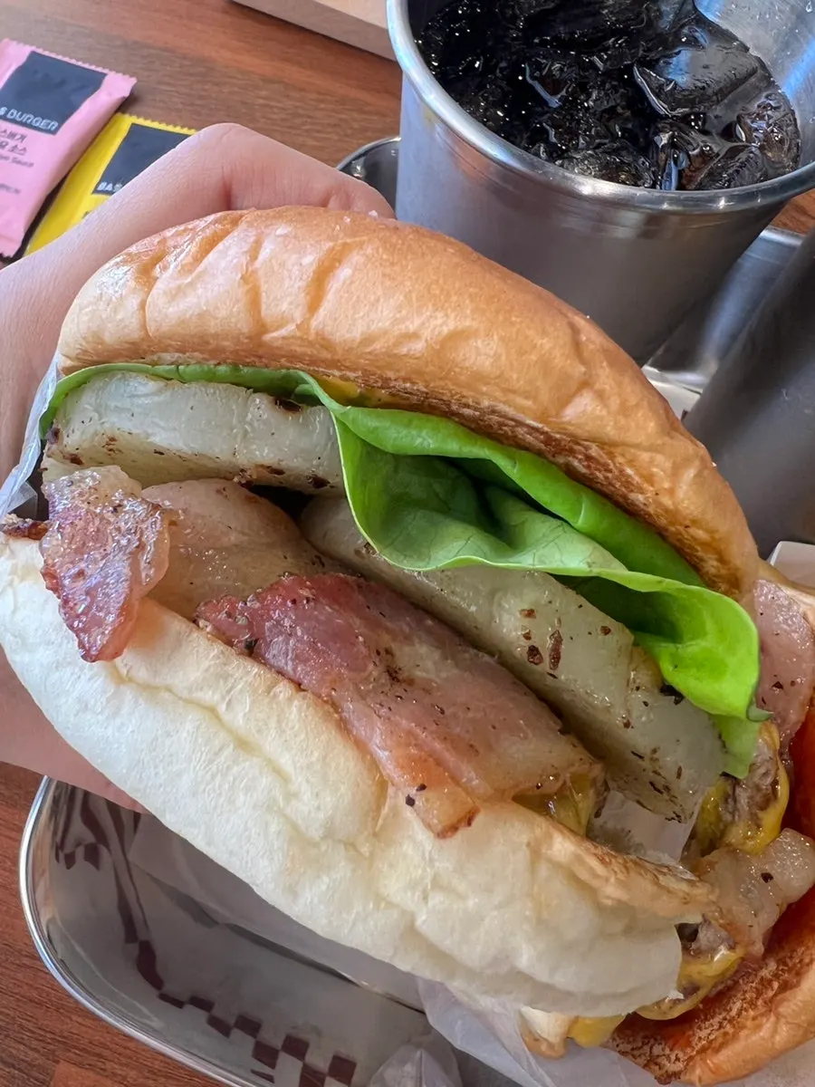 Burger showing its fluffy bun and sauce
