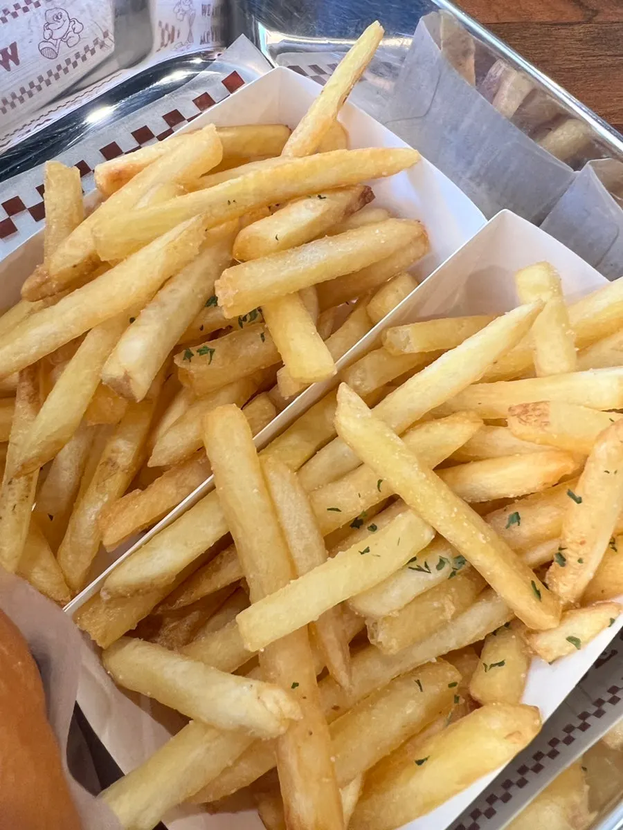 Burger and fries dipped in sauce