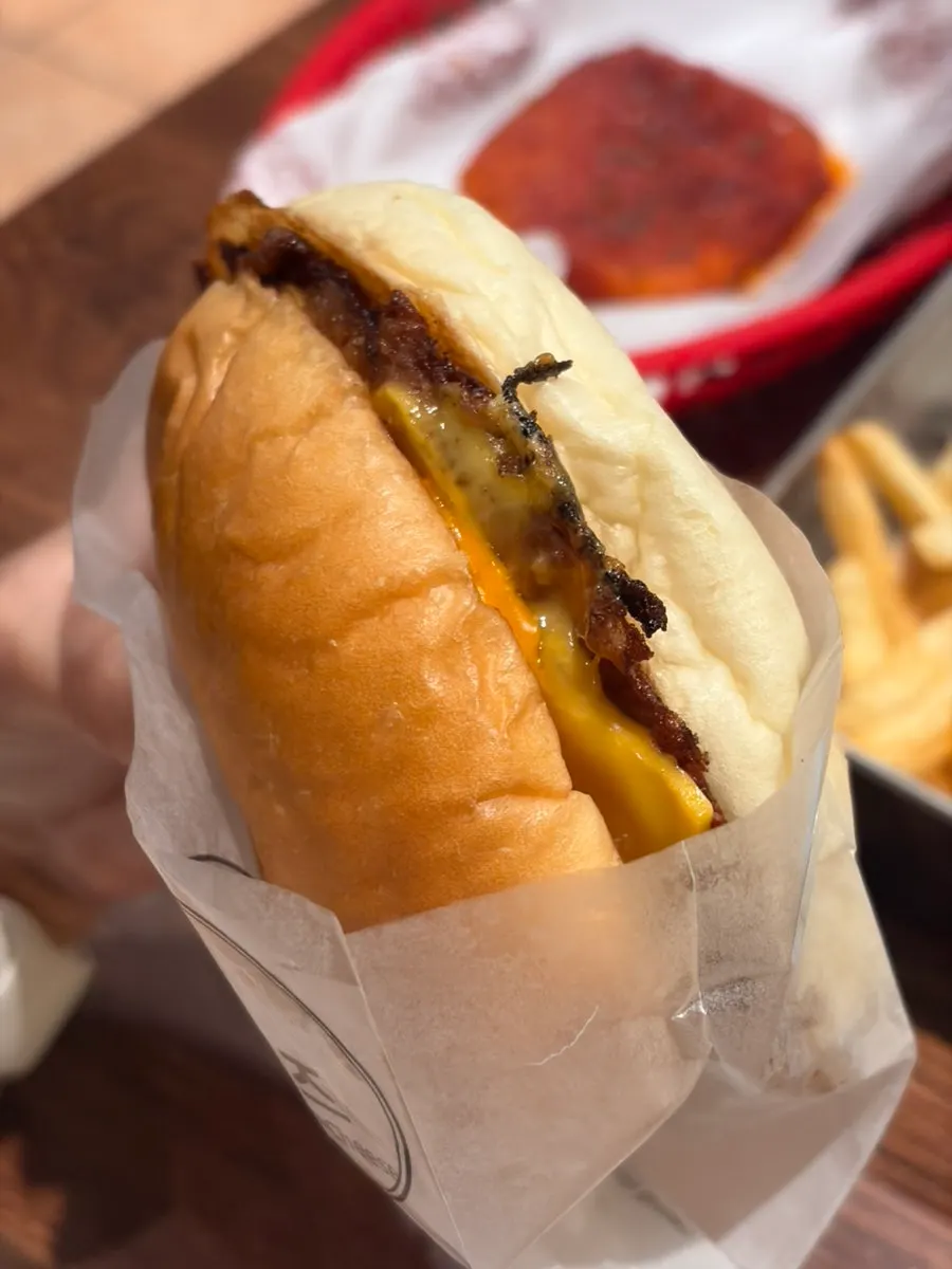 Handmade burger stacked with patty and ingredients