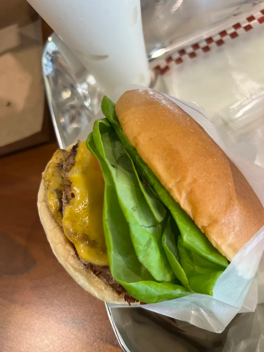 Double Bas Burger with visible tomato and vegetables