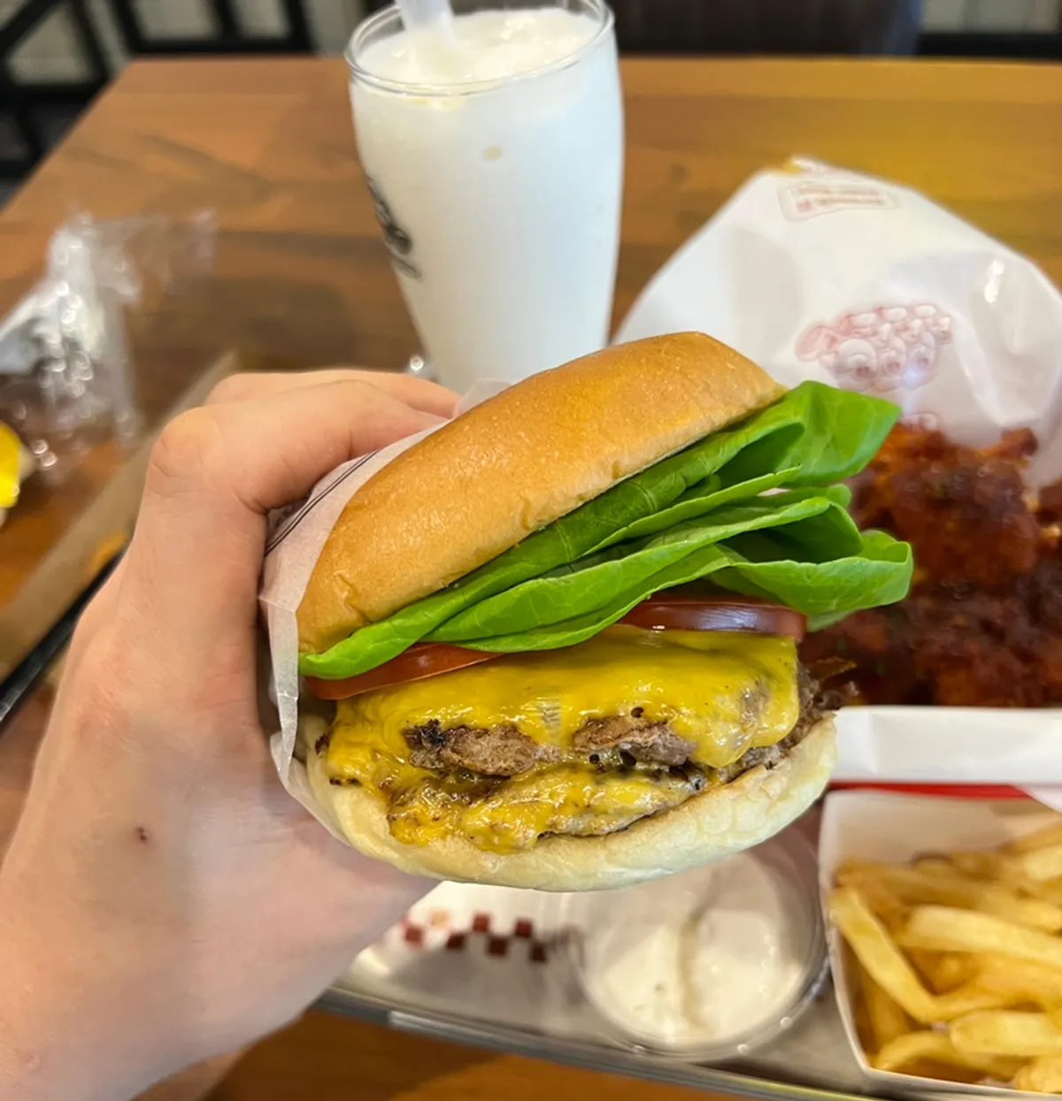 Double Bas Burger and fries spread on the table