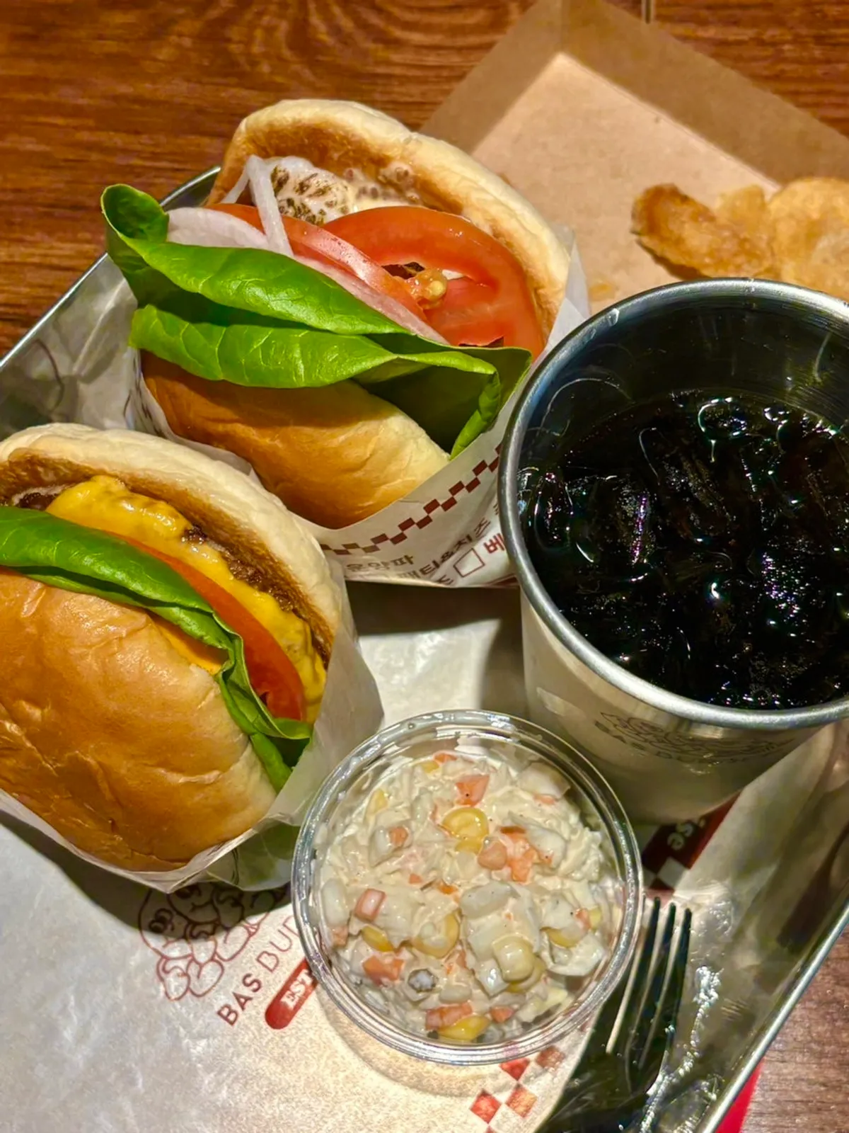 Table spread with the Wasabi Mayo Shrimp Burger single and Bas Burger set