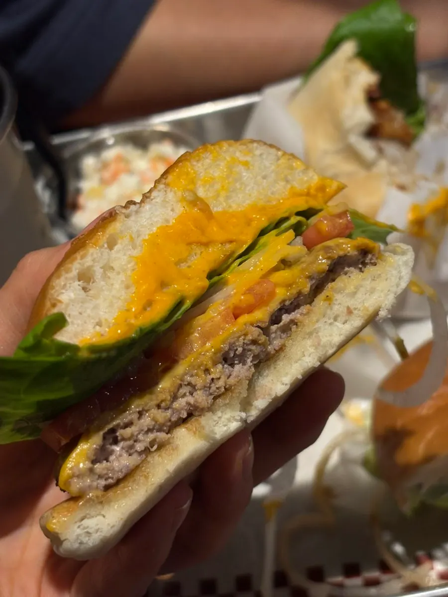 Bas Burger split in half with house sauce visible
