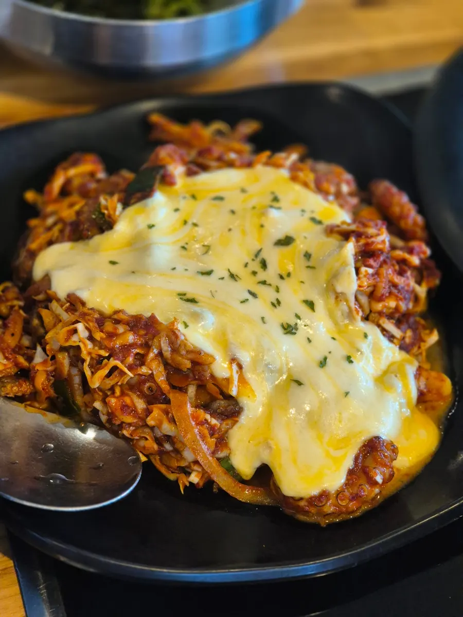 Fire-grilled octopus stir-fry for two with cheese added