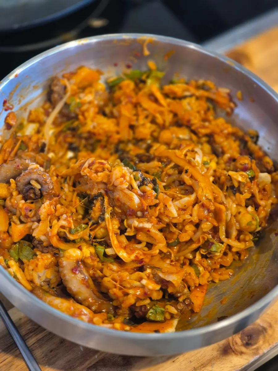 Fire-grilled octopus bibimbap mixed in a bowl