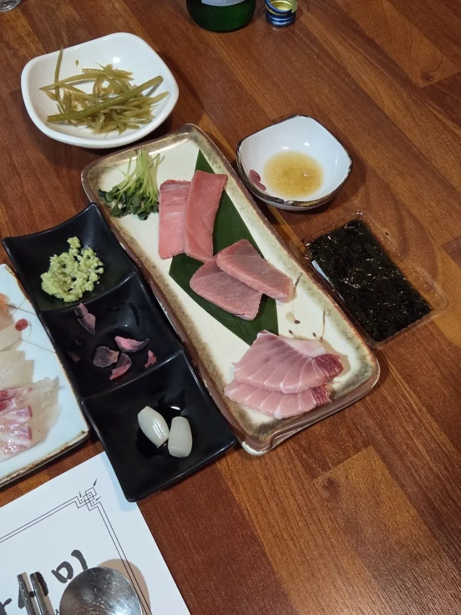 Plate of drinking snacks including soy sauce shrimp and octopus wasabi