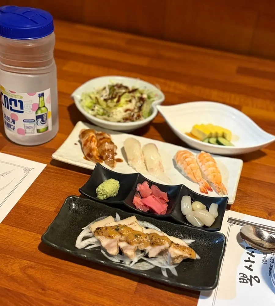 A full spread of side dishes from the mixed sashimi course