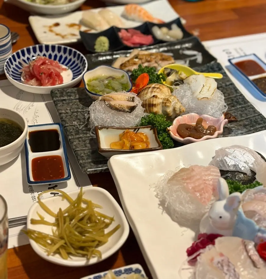 Table spread with seafood and mixed sashimi
