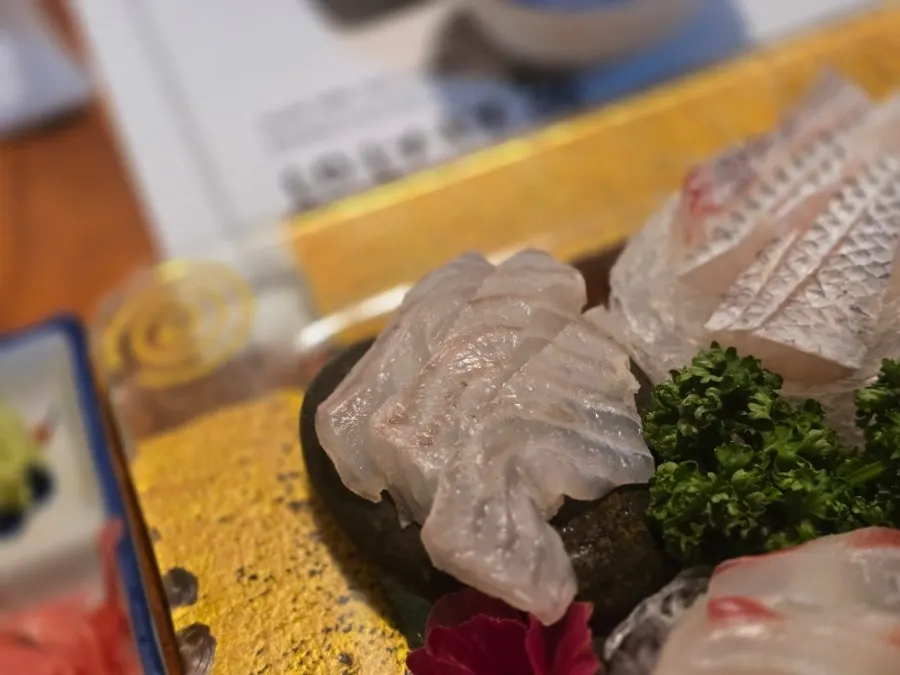 A single thick-cut piece of sashimi