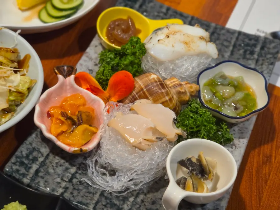 A plate of abalone, whelks, and other seafood