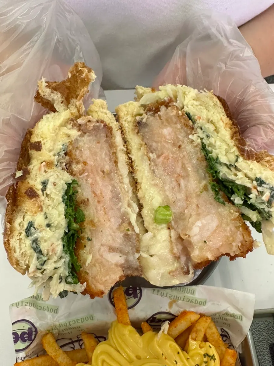 Holding the Wasabi Shrimp Big Burger in hand