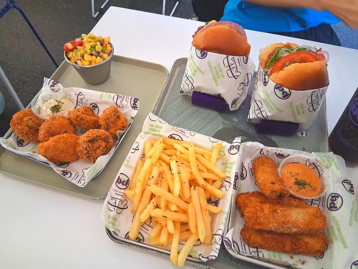 A full spread of burgers and sides ordered at bd Burger Seongsu