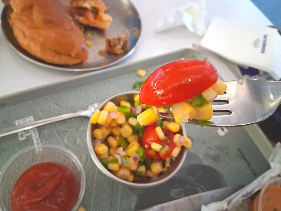 Refreshing corn salad eaten alongside the burgers