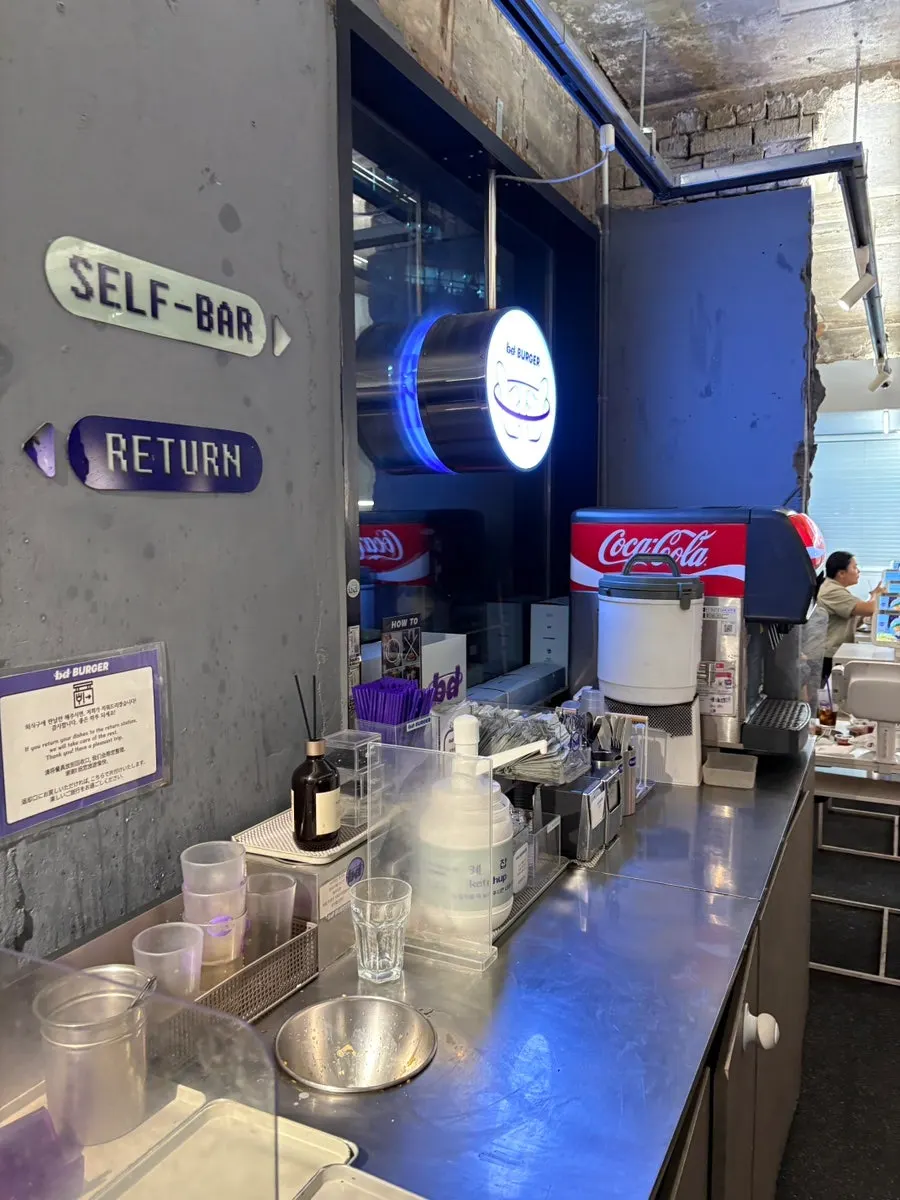 Water, cups, and ketchup at the self-bar