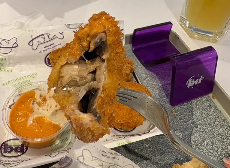 Fritters eaten alongside a beer