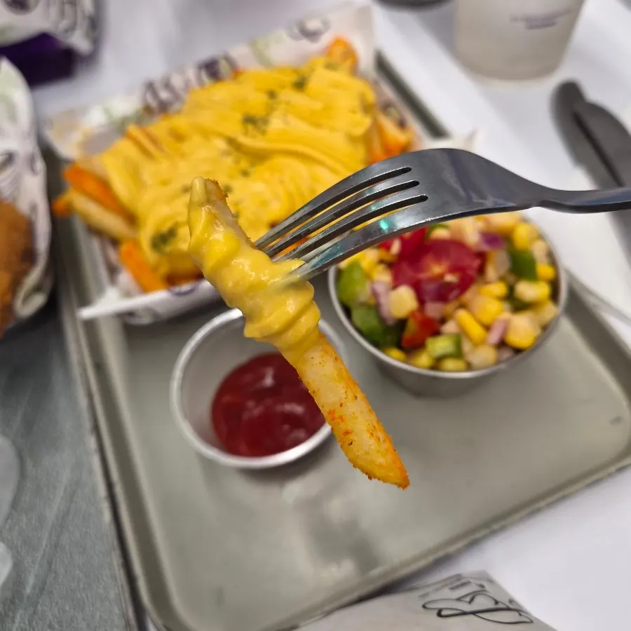 Fresh corn salad eaten alongside the burger