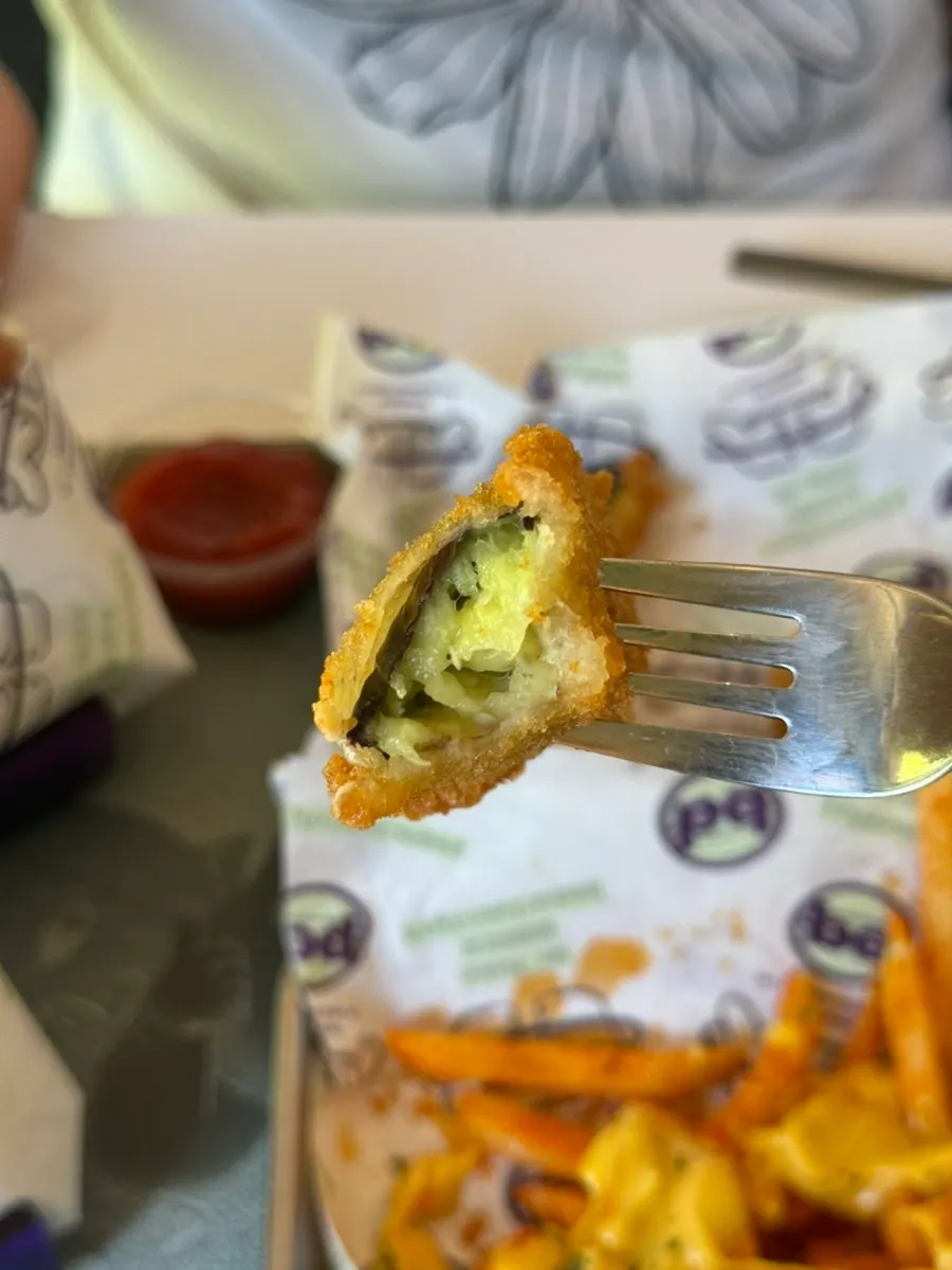 Fritter dipped in ranch sauce