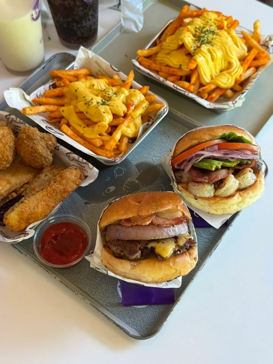 Full spread of burgers and sides at bd Burger Seongsu