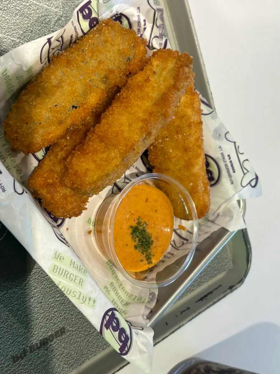 Wasabi shrimp burger held in hand