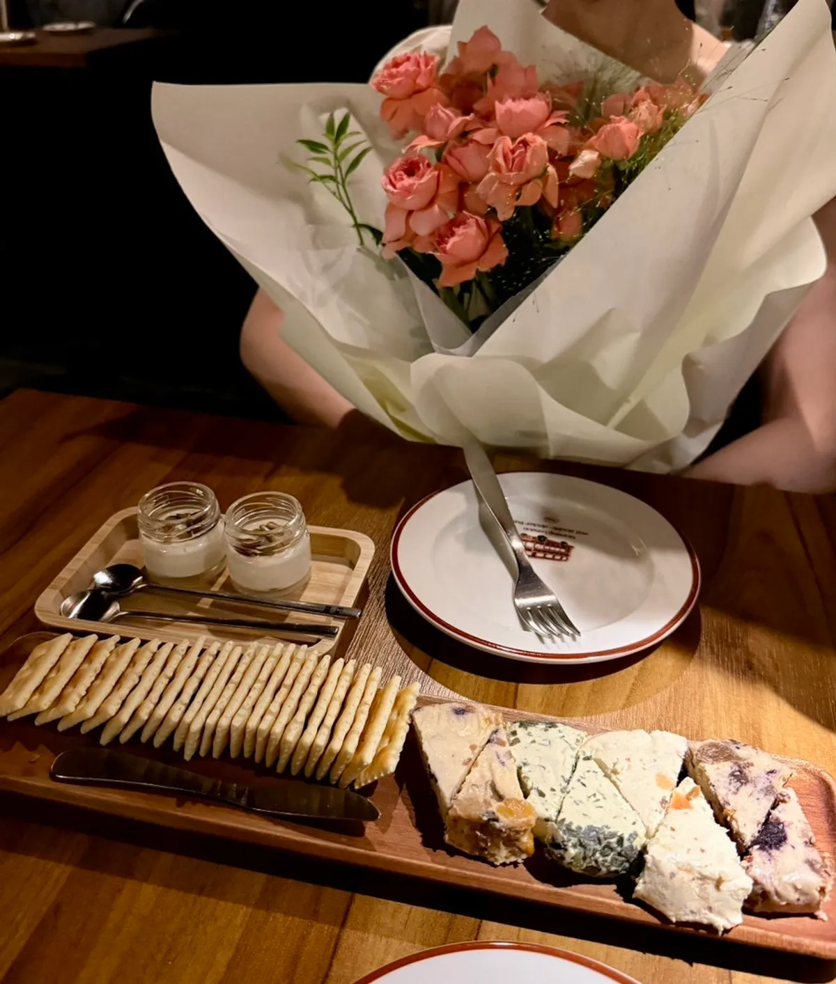 Fruit-flavored cheese and crackers on a wooden tray
