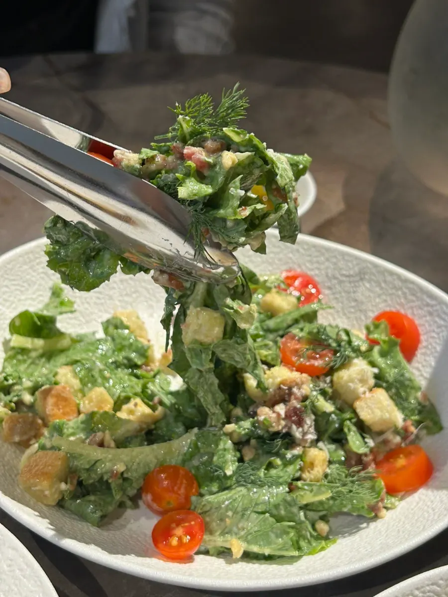Close-up of the Caesar salad topped with dill