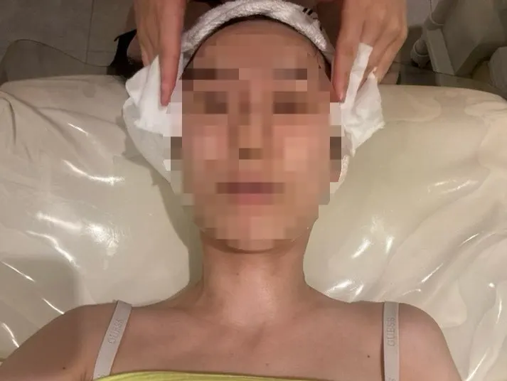 Changing into a disposable gown to prepare for treatment