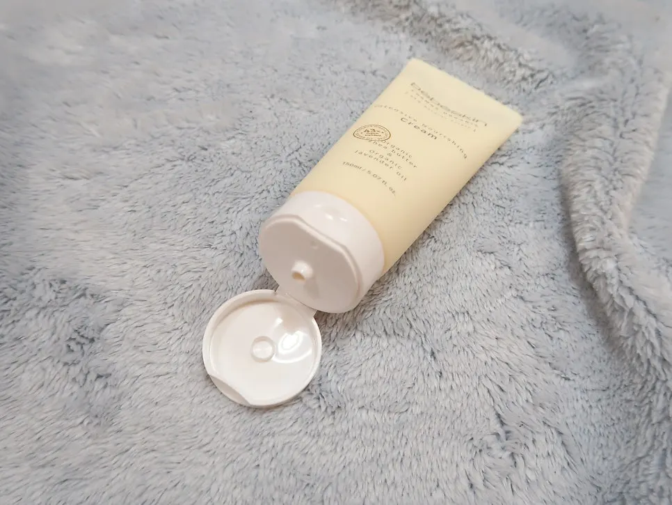 Cream container opening with a protective seal attached