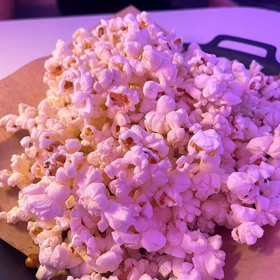 Butter popcorn served alongside cocktails