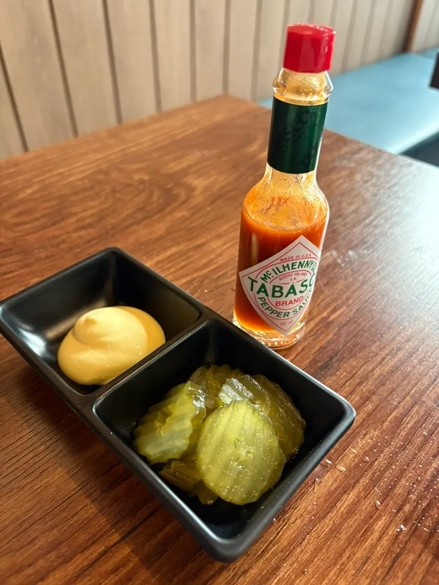 Pickles served alongside the pizza