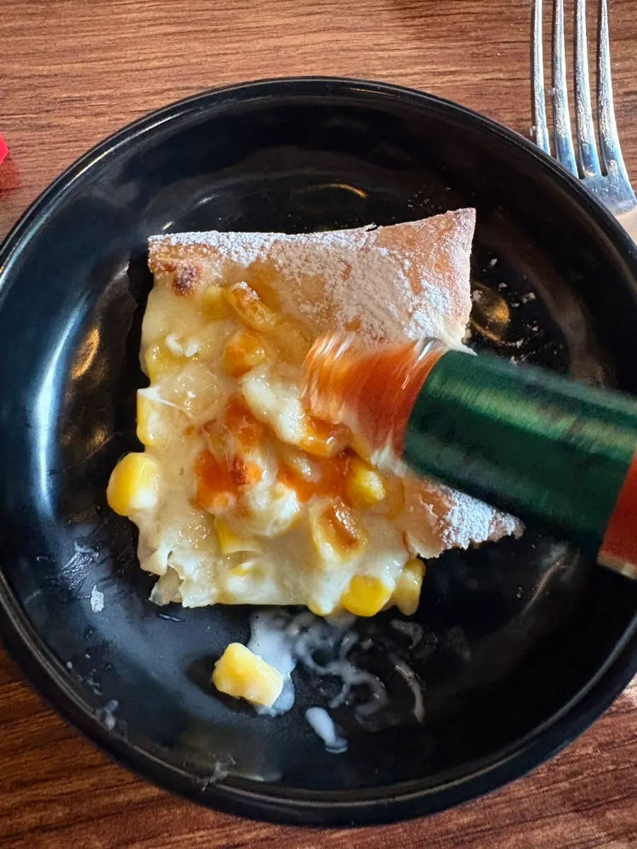Hot sauce served with the pizza