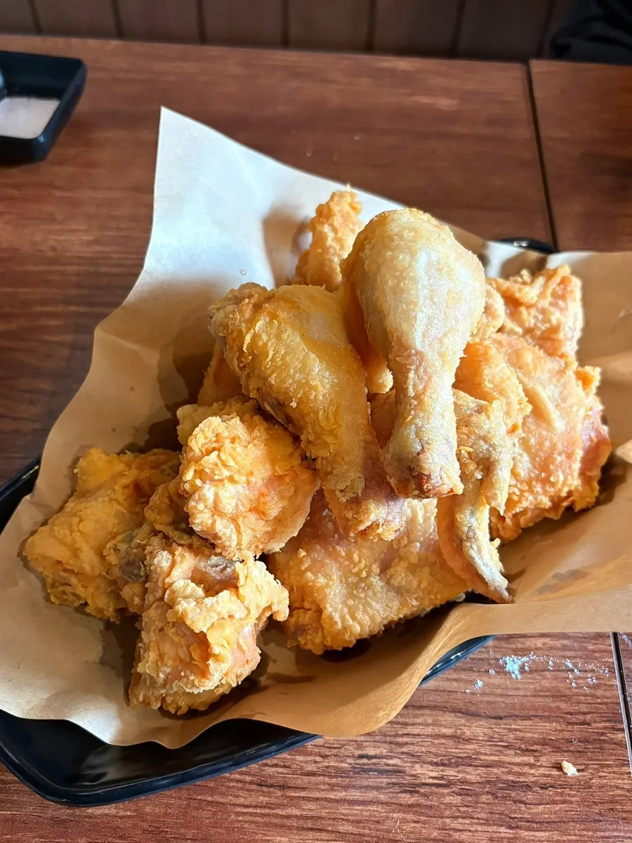 Whole fried chicken with accompanying sauces