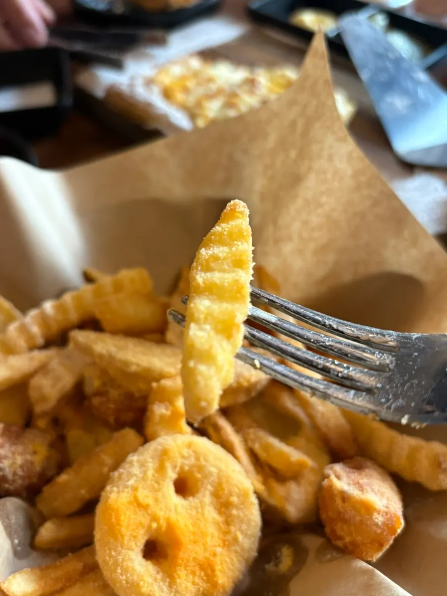 Various fried snacks including smiley-face potatoes