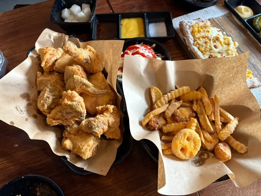A generous spread of chicken, pizza, and fries
