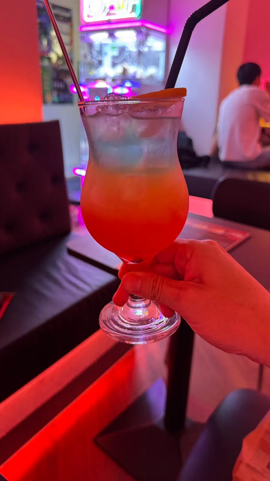 Glass of the radiant-colored V-Lab Paradise cocktail