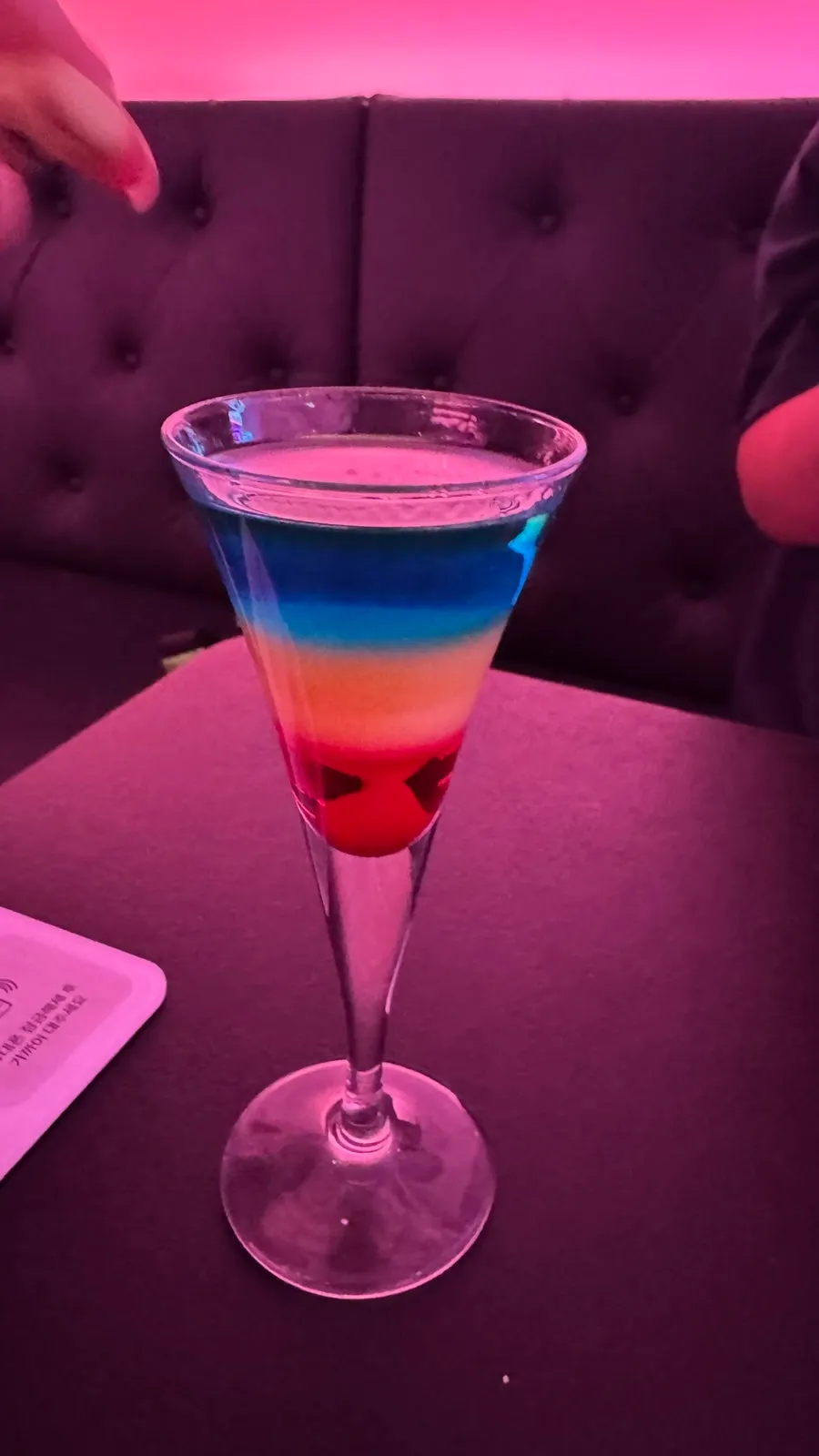 Flaming rainbow-colored liquor cocktail on fire