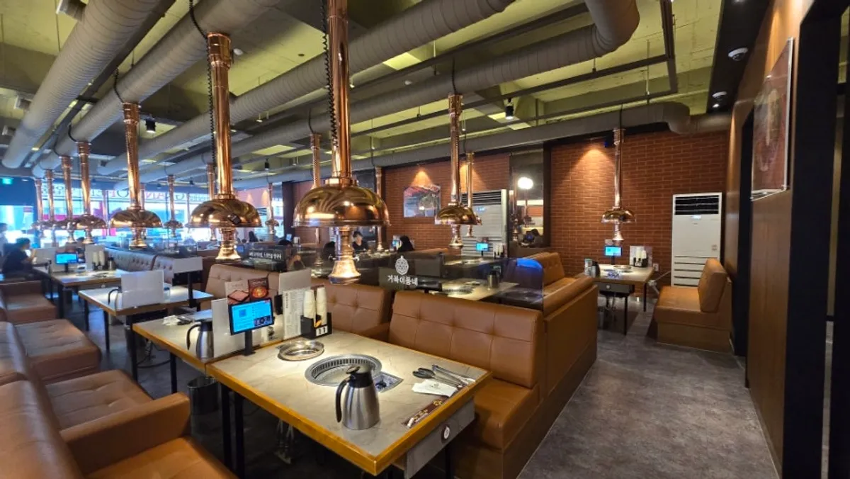 Spacious interior with brown seating and brick decor