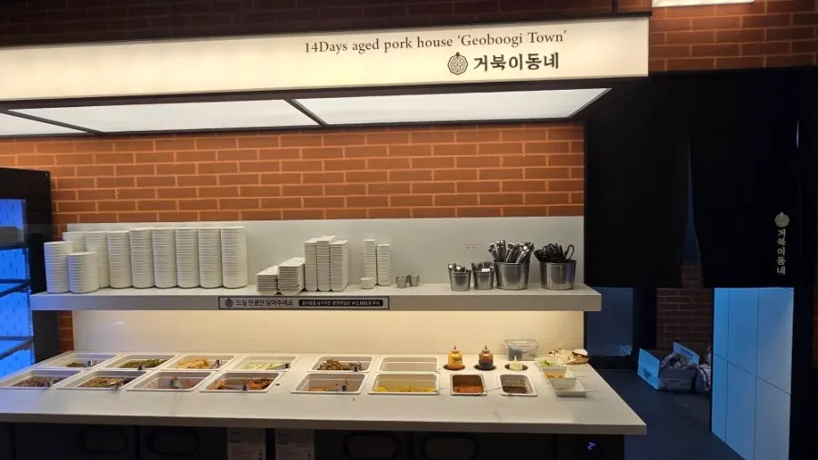 Self-serve bar with side dishes and sauces