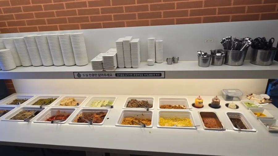 Self-serve bar corner with side dishes to pair with the meat