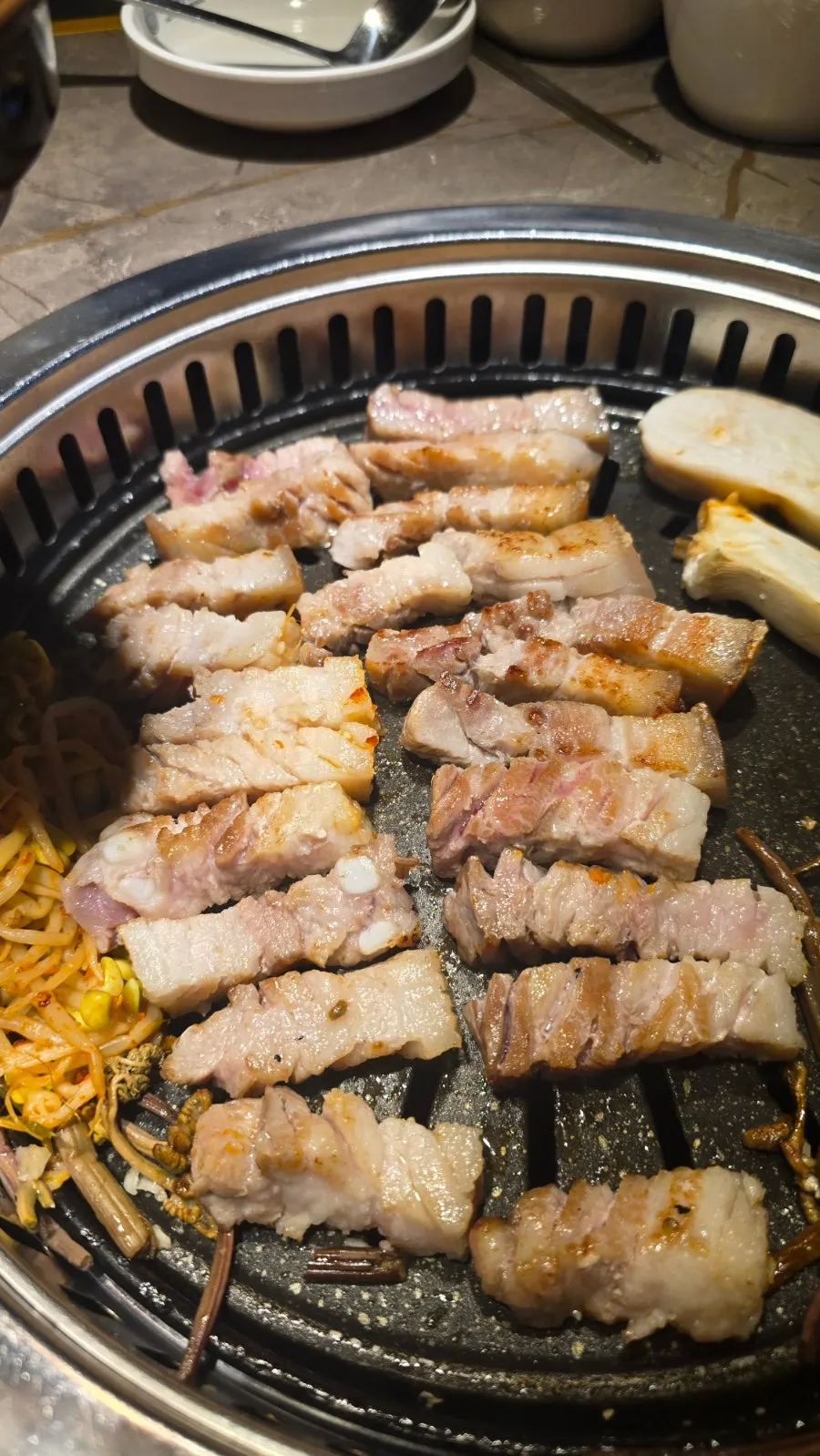 Bean sprouts and bracken fern grilled together with the meat