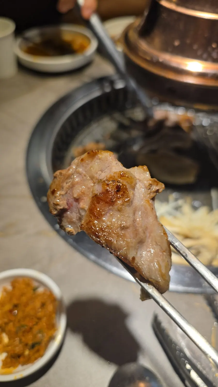 Aged pork neck cooking on the grill