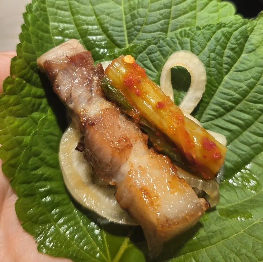 Perilla leaf wrap with aged pork and gat kimchi