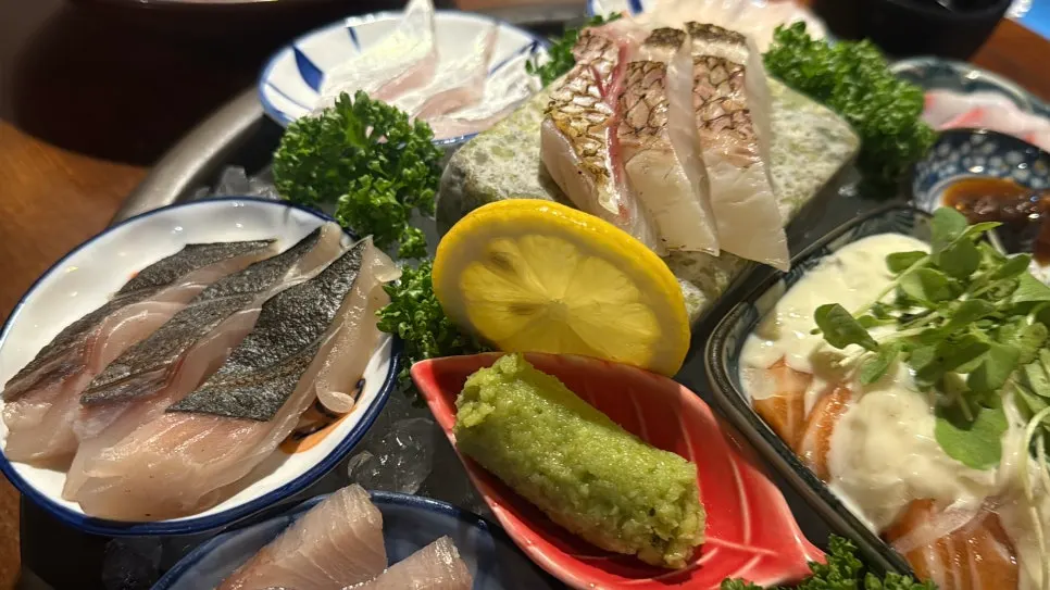 Various types of aged sashimi spread across small plates
