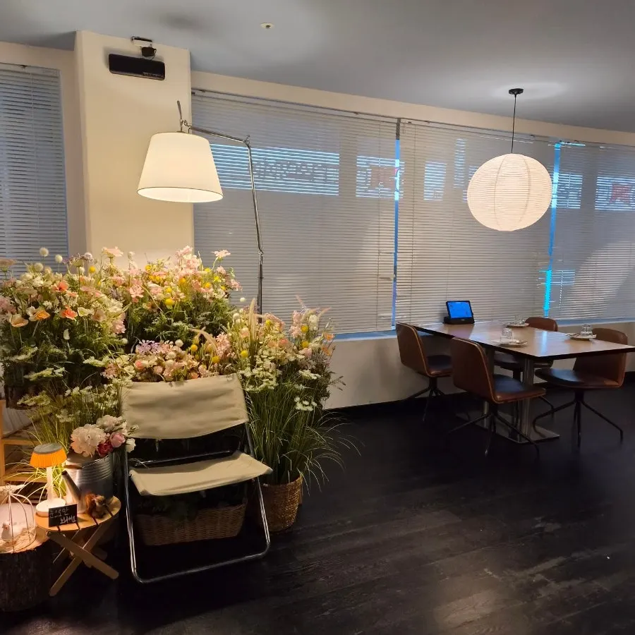 Window seating with flower decorations at Two Find Peter Beomgye Branch