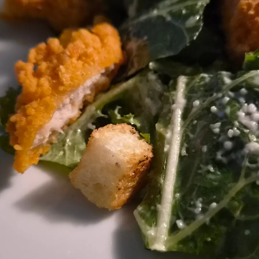 Caesar salad topped with cheese and croutons