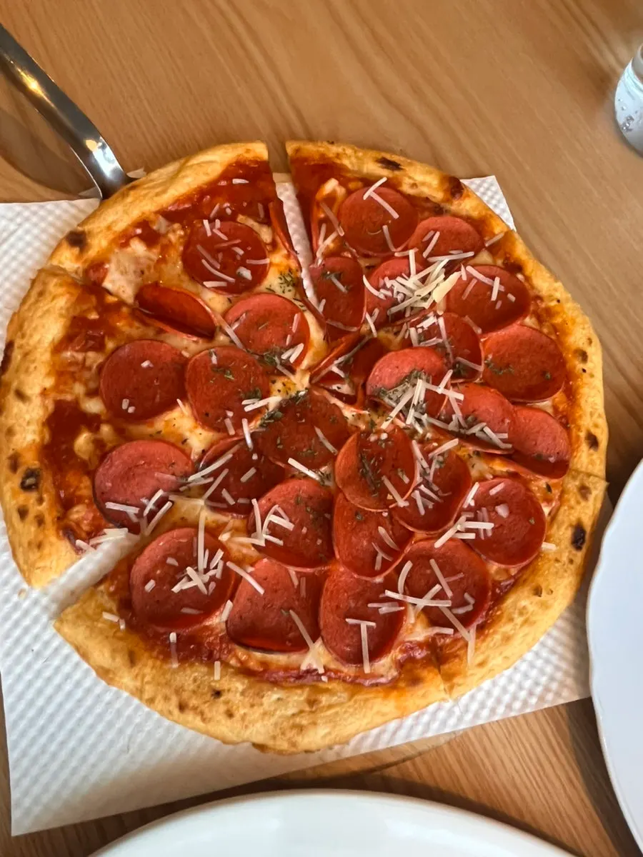 Pepperoni pizza with pepperoni packed densely on top