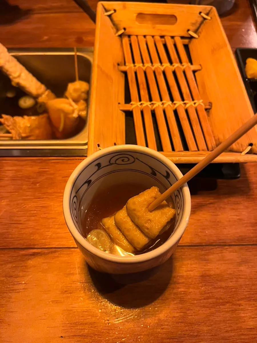 Squiggly fish cake pulled from the broth