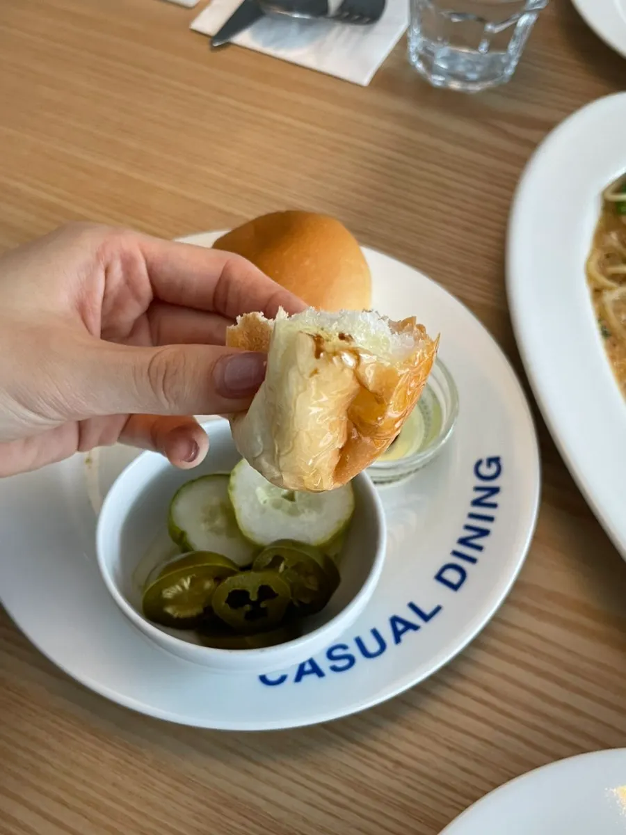 Dinner rolls and pickles served as starters